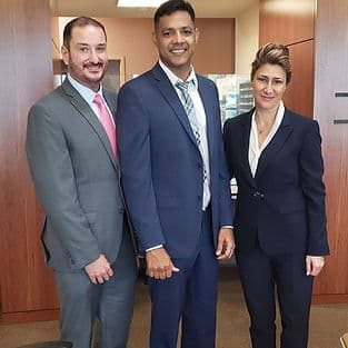 Emel Ersan with clients at the Tampa immigration office after winning their case